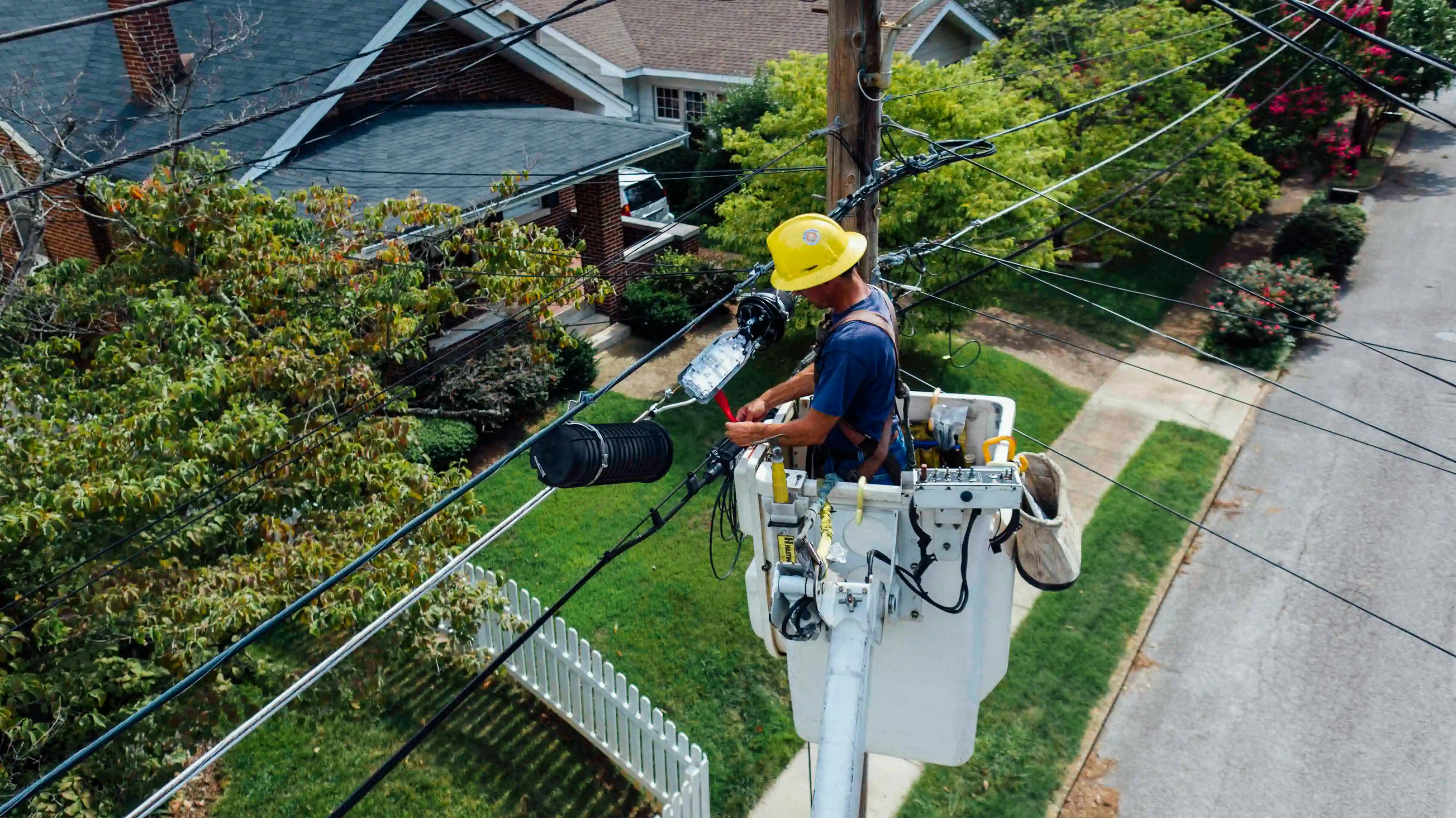 Expert electrical work services by Rafnacon in Pakistan, featuring a skilled electrician installing wiring in a residential setting.